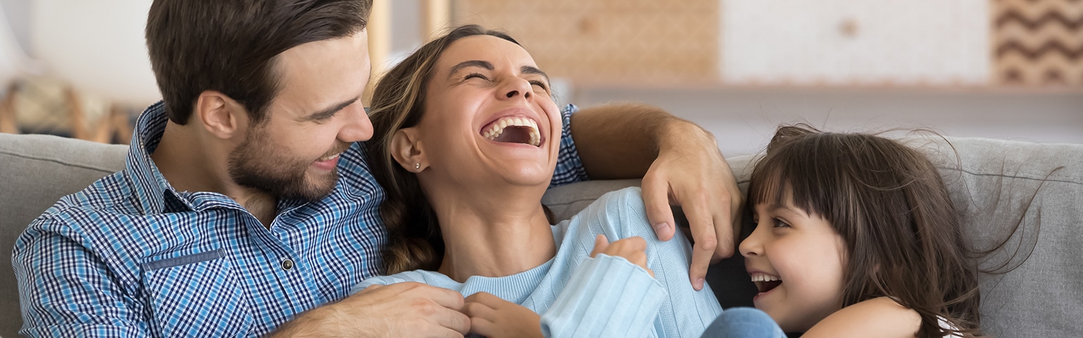 Parents and child laughing together